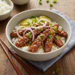 hot honey beef bowl served with rice and toppings