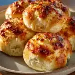 Soft garlic rolls brushed with melted butter and fresh herbs, freshly baked and golden brown