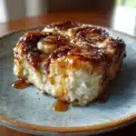 Cinnamon Roll Cottage Cheese Bake 4 Golden cinnamon roll cottage cheese bake with glaze in a ceramic baking dish